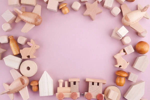 Zero waste. Frame from eco wooden toys on pink background. Flat lay. Top view — Stock Photo, Image