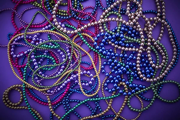 Background of colorful mardi gras beads including gold, green and purple — Stock Photo, Image