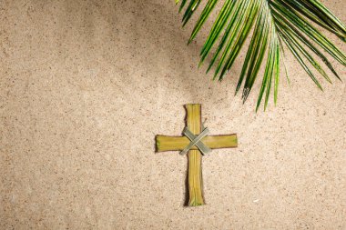 Cross ve Palm Tree kumsalda yaprak bırakıyor. Palm Sunday konsepti. Üst görünüm