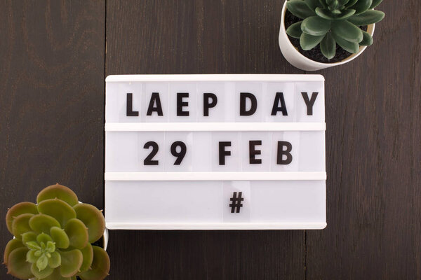 Date of the Leap Day. Calendar on wooden background