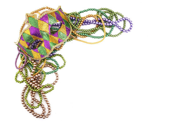 holiday or mardi gras beads and mask making frame isolated on white background