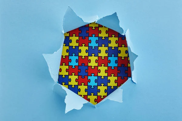 World Autism Awareness, concept with puzzle or jigsaw pattern in paper cut hole — Stock Photo, Image