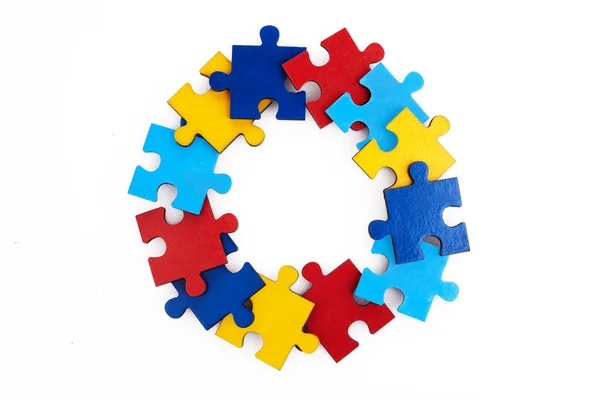 Colorful puzzles round frame on white background, early childhood autism concept, copy space, text space. — Stock Photo, Image