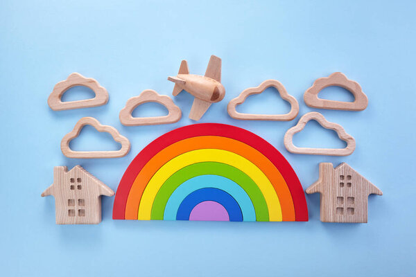 Colorful wooden toys background with rainbow. Preschool, childhood. Zero waste concept.