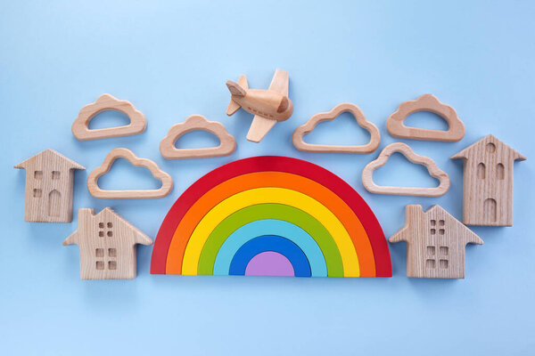 Colorful wooden toys background with rainbow. Preschool, childhood. Zero waste concept.