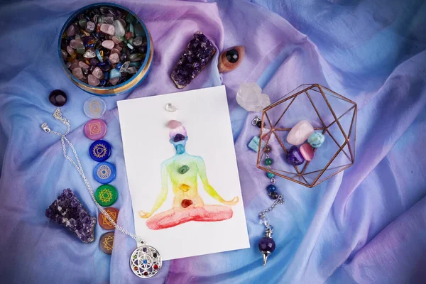 Natural crystals and pendulum on pastel silk background. Reiki background with card. — Stock Photo, Image