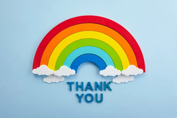 Thank you rainbow banner. Rainbow ob blue background with letters