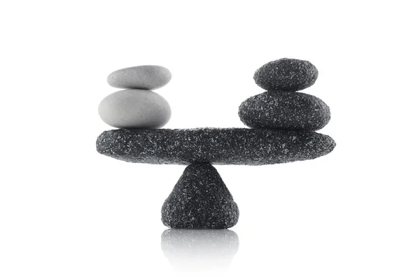 Balancing black and white stones isolated on white background