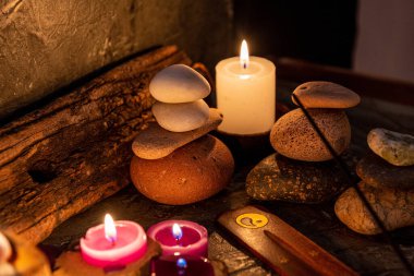 burning aromatic candles melted in rustic wood in low light