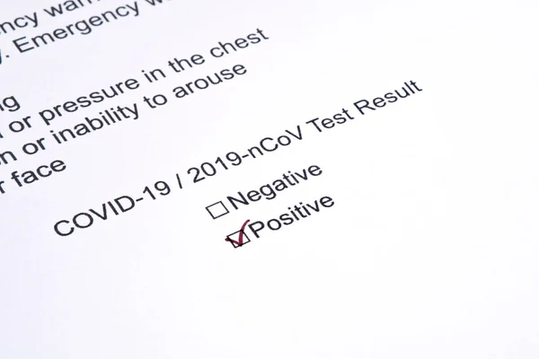 Positive test result for COVID-19 or novel coronavirus pandemic. Stethoscope and novel coronavirus test result on doctor's table