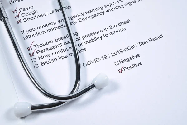 Positive test result for COVID-19 or novel coronavirus pandemic. Stethoscope and novel coronavirus test result on doctor\'s table