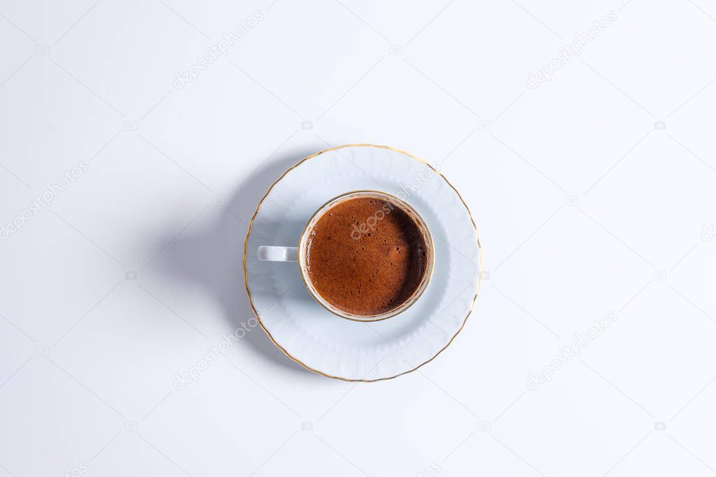 Top view of a cup of Turkish coffee in traditional white porcelain Turkish coffee cup