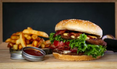 Marul, peynir, soğan ve domatesli nefis ev yapımı hamburgerler.