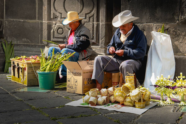 Mexican Latino artisans working with palm material to make religious figures and bags