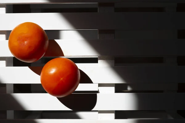 Two tomatoes on a white background. Tomatoes concept.