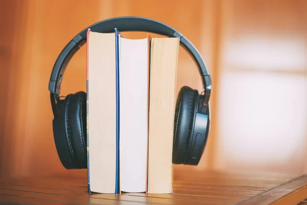 Books with headphones. Audiobook concept.