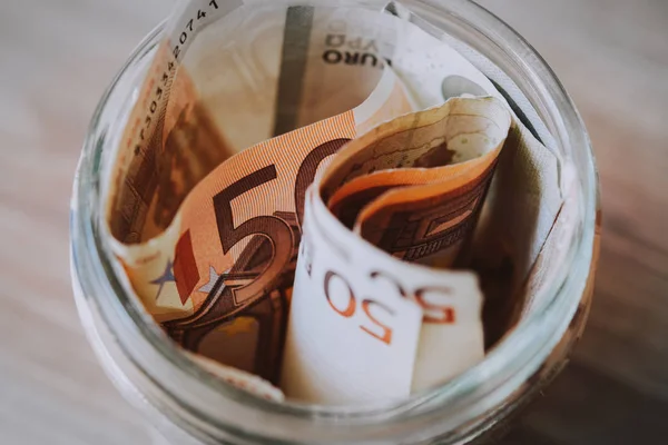 Billetes de euros en un vaso — Foto de Stock