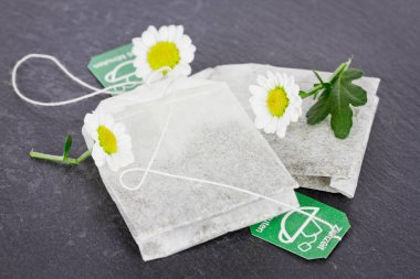 teabags with camomiles close up clipart