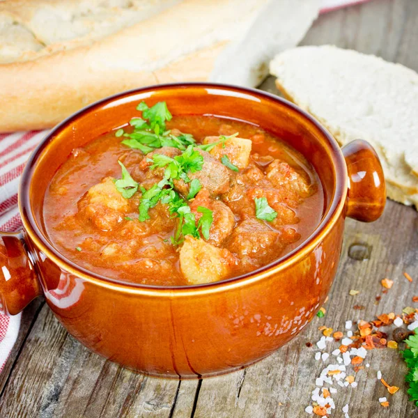 Goulash soup on wooden table — Stock Photo, Image