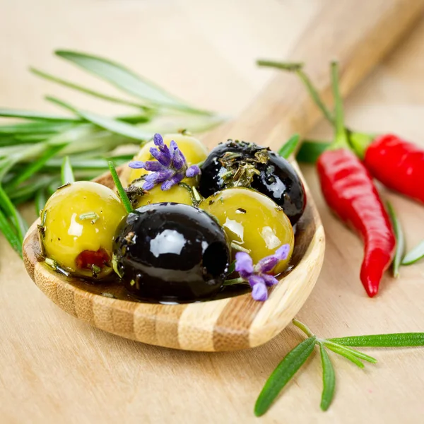 Olives on wooden spoon — Stock Photo, Image