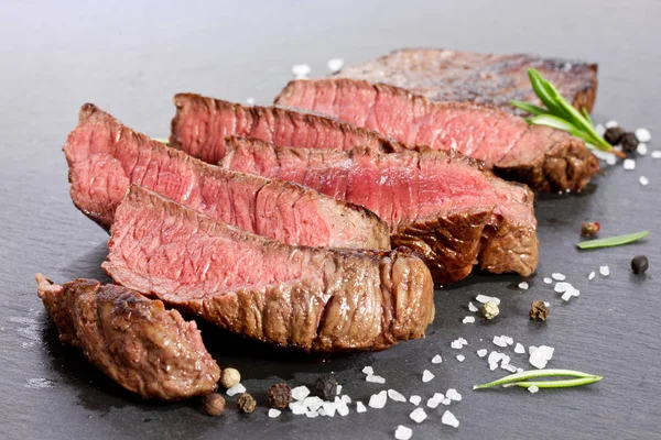 Medium rare grilled steak sliced up — Stock Photo, Image