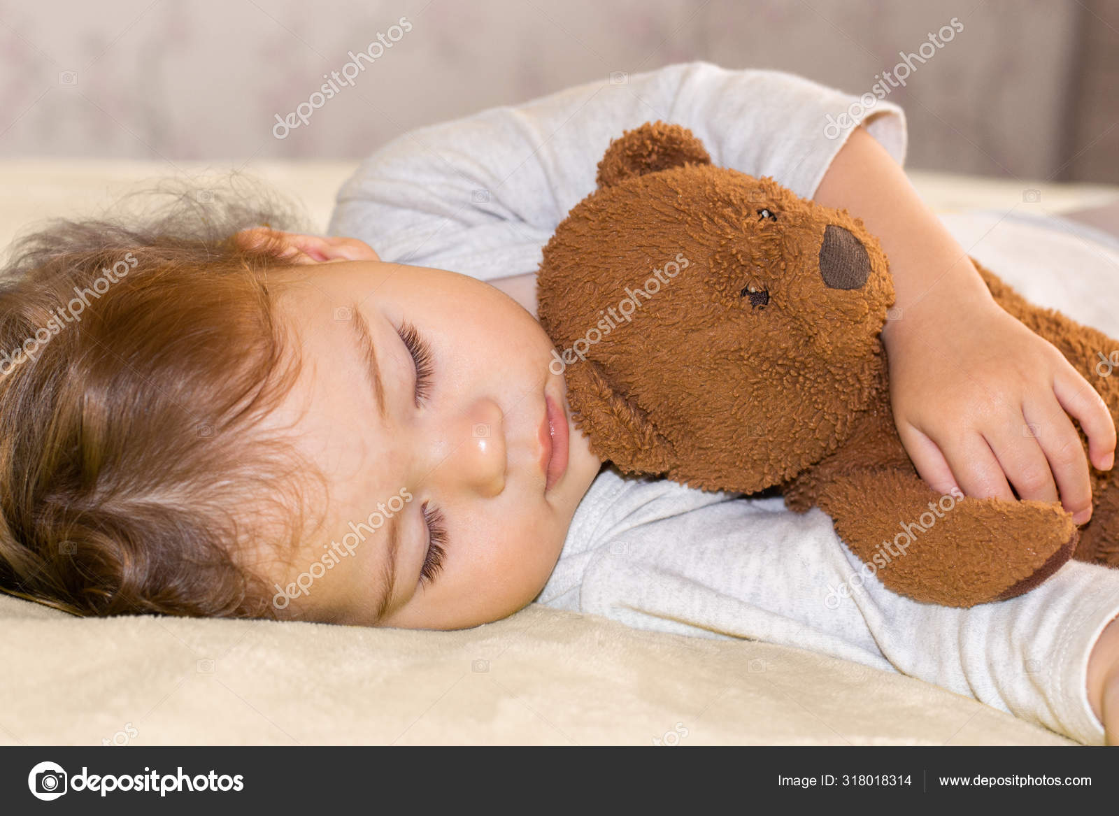 baby sleeping with teddy