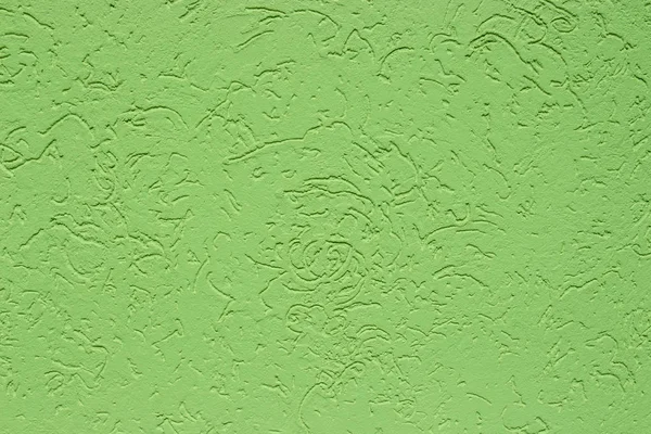 Green stucco, wall decoration, texture. The rough surface of the concrete wall with colored lime plaster.