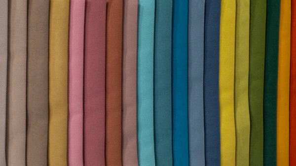 Multi-colored strips of fabric, samples of textile material. Soft fleecy fleece, a palette of color shades