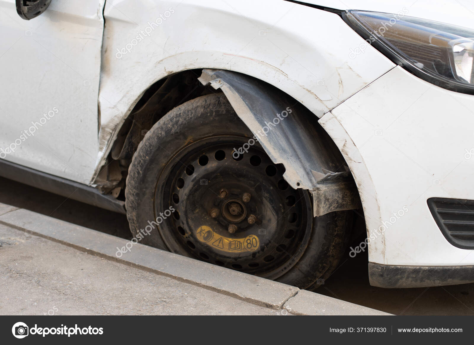 Broken Car after a Crash. Damaged Wing and Headlamp of a Car