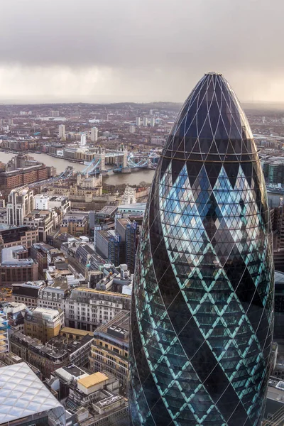 Famous London Gherkin tower with a Tower Bridge on a background — Stock Photo, Image