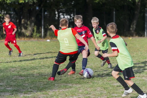 Chicos jugar al fútbol en el campo de deportes —  Fotos de Stock