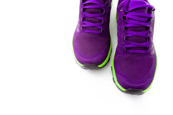purple sneakers on a yellow isolated background