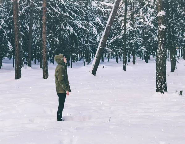 Young man in winter forest