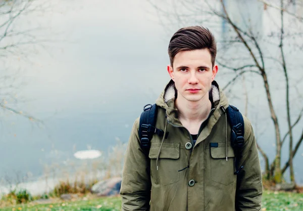 Young man by river — Stock Photo, Image