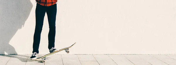 Man standing On Skateboard