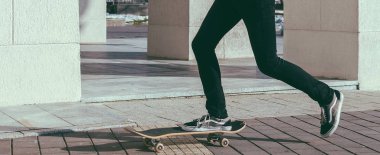 Genç adam kaykaya biniyor. 