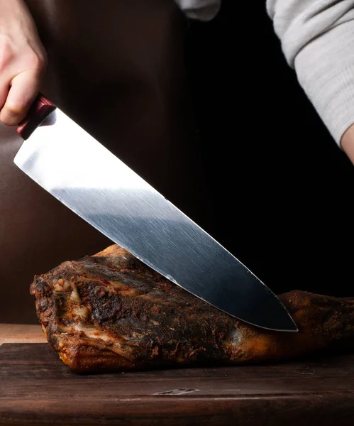 Gemide et kesmek için bıçak, jamon, kurutulmuş et, dana eti. Kuru jambon, Parma jambonu, siyah arka planda bütün bacak izole edilmiş. Kurumuş İtalyan bacağı. Tütsülenmiş biftek. Tahtada kurutulmuş sigara. Et dükkanı