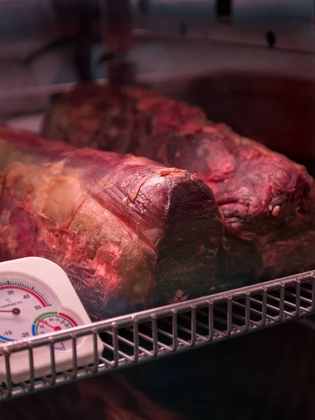 Prepare dried meats. Beef jerky. Jerky. Meat shop. Marbled beef dry aging lies in the refrigerator Whisky Dry-Aged Steaks. Beef & Glory, Display of Dry Aged Meat Steaks in butchers shop or restaurant