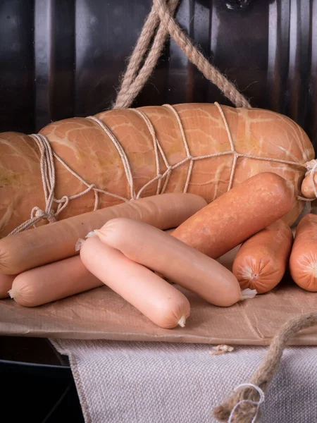 Sliced boiled ham sausage. hot dog sausage. sausages still life smoked meat SAUSAGE PRODUCT , Gastronomy meat, Organic sausage . Meat for beer , Sausage for beer