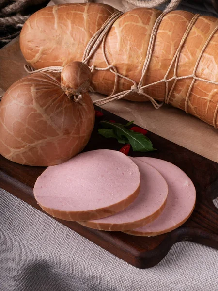 Sliced boiled ham sausage. hot dog sausage. sausages still life smoked meat SAUSAGE PRODUCT , Gastronomy meat, Organic sausage . Meat for beer , Sausage for beer