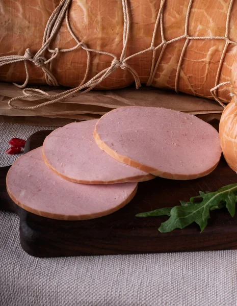 Sliced boiled ham sausage. hot dog sausage. sausages still life smoked meat SAUSAGE PRODUCT , Gastronomy meat, Organic sausage . Meat for beer , Sausage for beer