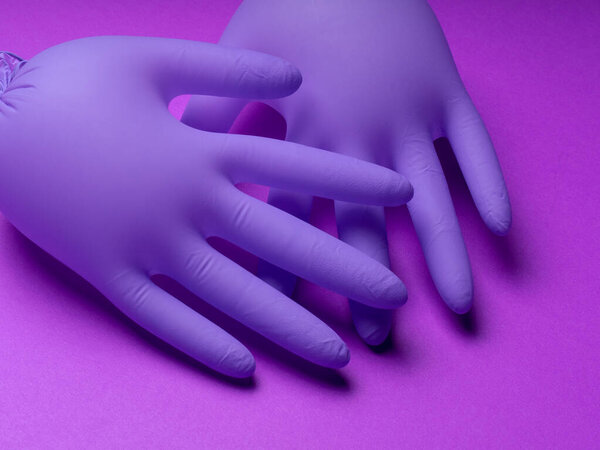 COVID-19. Epidemic background.  Quarantine background. Medical gloves for protection. Dangerous virus. gloves on  dark background .  gloves for test.copy space. Coronavirus