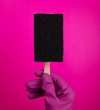 Çubukta dondurmalı sünger. Elde bulaşık yıkamak için sünger. İzole edilmiş bir lateks eldiven verin. Eldivendeki bir el, yıkama ve temizleme için bir sünger tutar. Temizlik ya da temizlik konsepti. Metin veya reklam çerçevesi