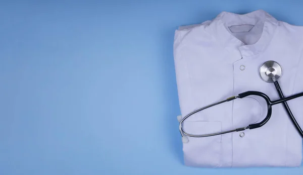 white medical dressing gown on blue background