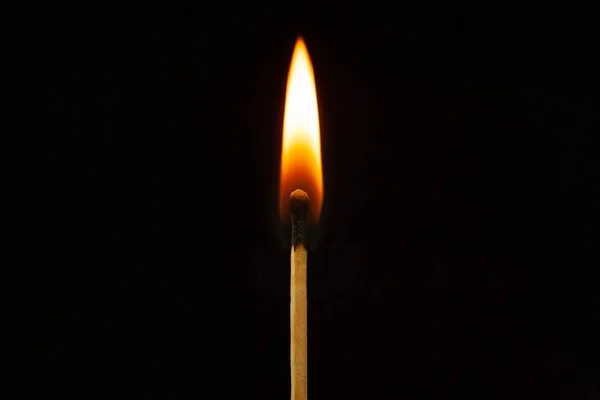 One burning match on the black background isolated side view — Stock Photo, Image