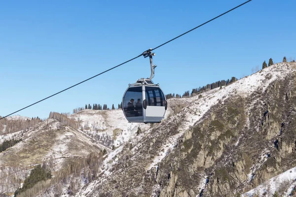 Two passengers on a cable car high in the mountains — Stock Photo, Image