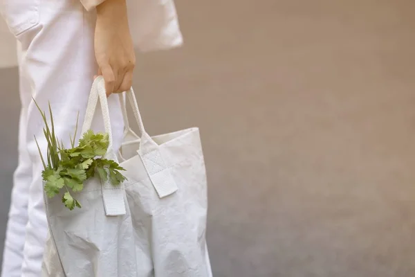 Young women use recyclable bags to shop for vegetables in the fresh market in the morning to reduce global warming.