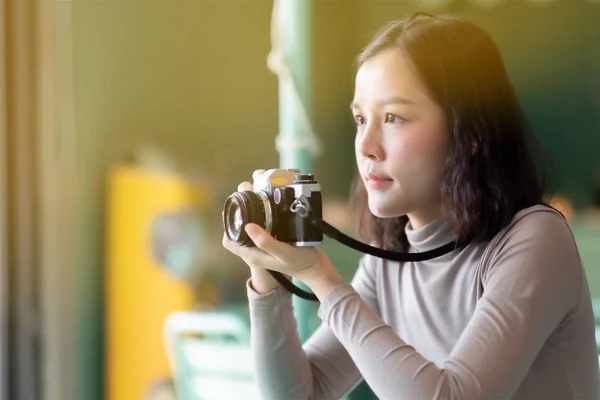 Asian woman photographer take a picture by film camera — Stockfoto