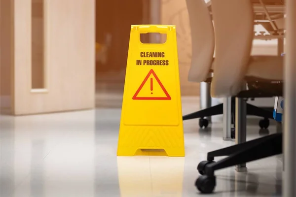 Yellow sign of caution reserve cleaning on the wet floor in office room — Stock Photo, Image