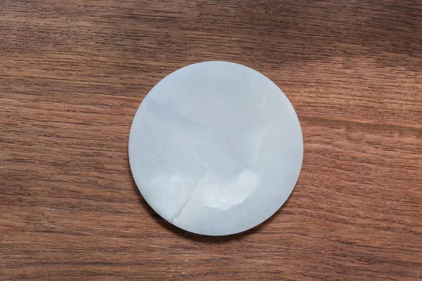 White marble dish on wood table — 스톡 사진